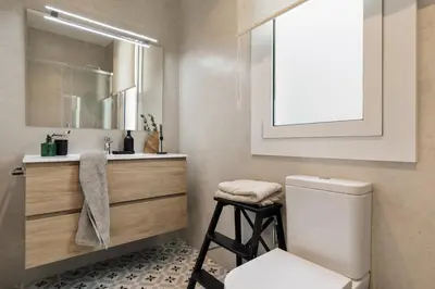 a bathroom with a sink and a mirror at Davut - 3 bedrooms and office in Eixample Esquerra in Barcelona