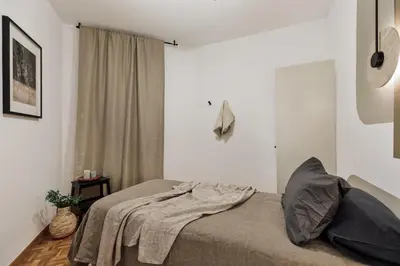 a living room with a couch and a tv at Nicoya - 3 bedrooms and balcony in Eixample Dreta in Barcelona
