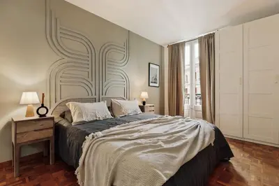 a white kitchen with a tote bag hanging on the wall at Nicoya - 3 bedrooms and balcony in Eixample Dreta in Barcelona