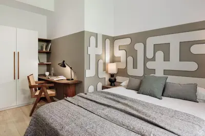 a bedroom with a large bed with two lamps at Roses - 1 bedroom and balcony in Sant Antoni in Barcelona