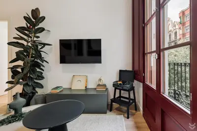 a kitchen with white cabinets and a dining room at Roses - 1 bedroom and balcony in Sant Antoni in Barcelona