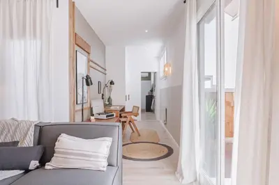 a kitchen with a table and a washing machine at Nerja - 1 bedroom and terrace in Sant Gervasi in Barcelona
