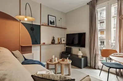a living room with a couch and a tv at Yesil - 2 bedrooms and office in Sant Antoni in Barcelona