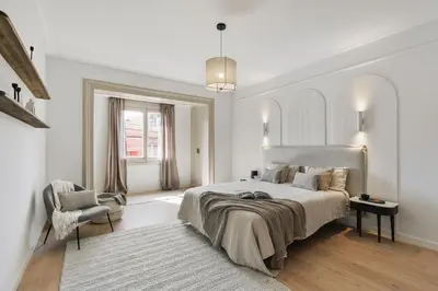 a living room with a fireplace and a chair at Rama - 3 bedrooms and terrace in Sant Gervasi in Barcelona