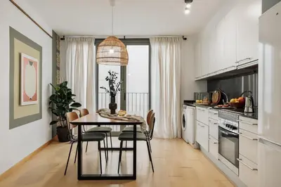 a living room with a white couch and a tv at Mercan - 2 bedrooms in Sant Pere in Barcelona