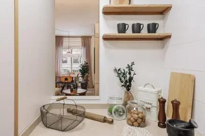 a living room with a couch and a table at Caliph - 2 bedrooms and office in El Putxet i el Farró in Barcelona