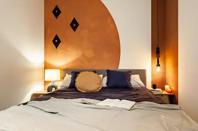 a bedroom with a large bed with two books on it at Kufra - 3 bedrooms in Eixample Esquerra in Barcelona