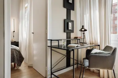 a bedroom with a bed with a book and a window at Holzer - 2 bedrooms in Sant Antoni in Barcelona