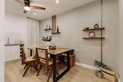 a black vase on a table next to a bed at Holzer - 2 bedrooms in Sant Antoni in Barcelona