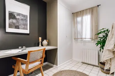 a room with a bed in a wooden wall at Sabre - 2 bedrooms and office in Gràcia in Barcelona