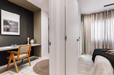 a white desk with a lamp and a chair at Sabre - 2 bedrooms and office in Gràcia in Barcelona