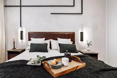 a bedroom with a tray of food on a bed at Sabre - 2 bedrooms and office in Gràcia in Barcelona