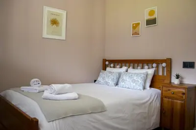 a bedroom with a bed with towels on it at LAMAGADA - Casa en Montseny con Piscina Salada in Seva
