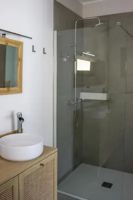 a bathroom with a sink and a glass shower at LAMAGADA - Casa en Montseny con Piscina Salada in Seva