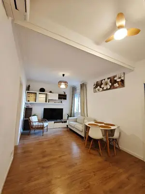 a living room with a couch and a table at Confort y Calma en Barcelona in Barcelona