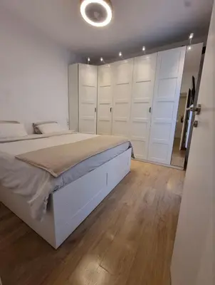 a bedroom with a large bed and white cabinets at Confort y Calma en Barcelona in Barcelona