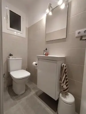 a white bathroom with a toilet and a sink at Confort y Calma en Barcelona in Barcelona