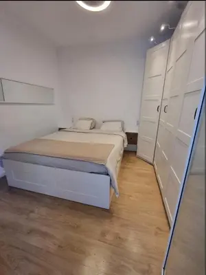 a white bedroom with a bed and a white cabinet at Confort y Calma en Barcelona in Barcelona