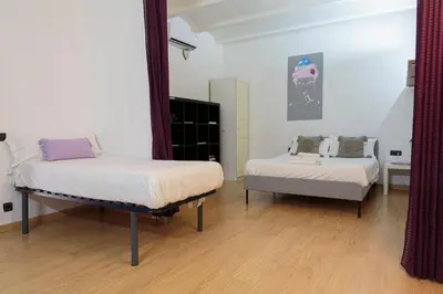 a bedroom with two beds and a mirror at Gracia&Güell Home in Barcelona