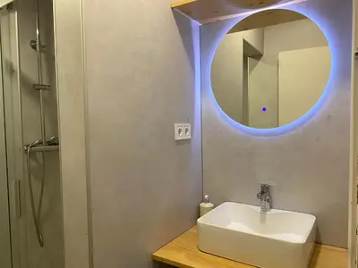 a bathroom with a sink and a mirror at Gracia&Güell Home in Barcelona