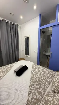 a bedroom with a bed with a black pillow on it at Cosy apartment next to the sea in Barcelona