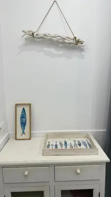 a white table with a shelf with blue and white vases at Cosy apartment next to the sea in Barcelona