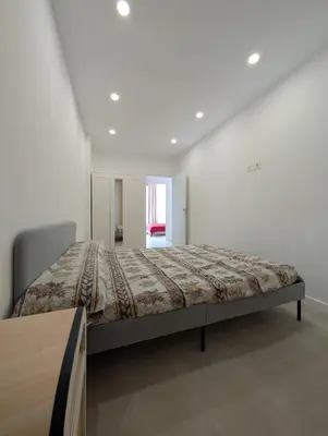 a bedroom with a bed in a white room at Ca l'Emília, hasta 6 pers, Monistrol de Montserrat in Monistrol