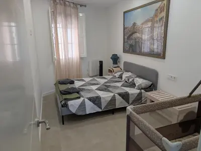 a bedroom with a bed and a picture on the wall at Ca l'Emília, hasta 6 pers, Monistrol de Montserrat in Monistrol