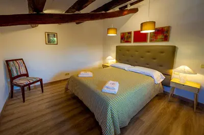 a bedroom with a bed with two towels on it at Cal Magí in San Martín Sarroca