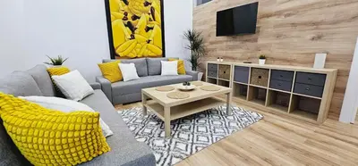 a living room with a couch and a tv at 2 apartamentos juntos ideal grupos cerca Barcelona in Badalona