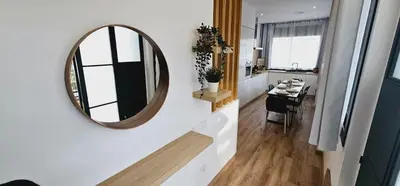 a mirror on a wall next to a kitchen at 2 apartamentos juntos ideal grupos cerca Barcelona in Badalona