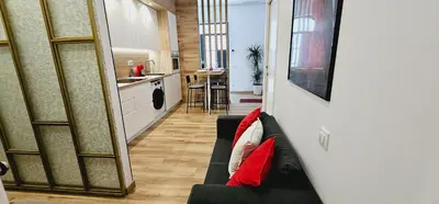 a living room with a couch and a kitchen at 2 apartamentos juntos ideal grupos cerca Barcelona in Badalona