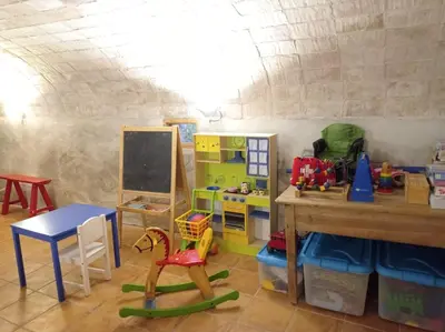 a room with a classroom with a table and a chalkboard at Casa rural Cal Farriol in Mediona