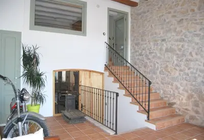 a staircase in a house with a stone wall at Casa rural Cal Farriol in Mediona