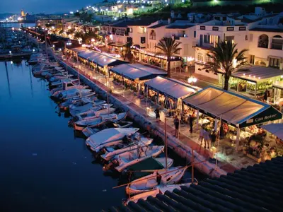 a group of boats docked at a marina at night at Benet Sitges in Sitges