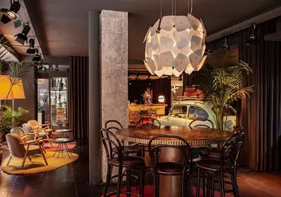 a dining room with a table and chairs and a chandelier at Sixties Ramblas in Barcelona