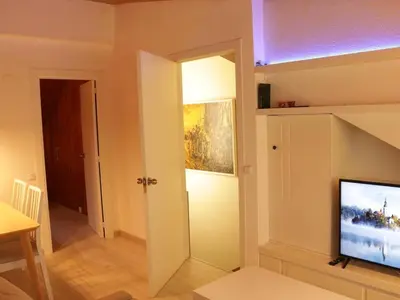 a living room with a flat screen tv on a wall at Winahost Loft en casa compartida en Cabrils in Cabrils