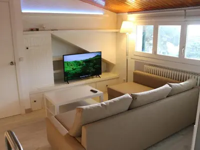 a living room with a couch and a flat screen tv at Winahost Loft en casa compartida en Cabrils in Cabrils