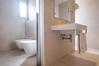 a bathroom with a sink and a toilet at Hotel Turin Barcelona in Barcelona