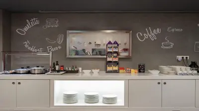 a kitchen with a counter with plates on it at Hotel Turin Barcelona in Barcelona