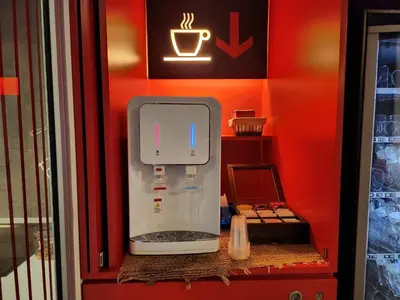 a red wall with a small refrigerator in a room at Hotel Turin Barcelona in Barcelona