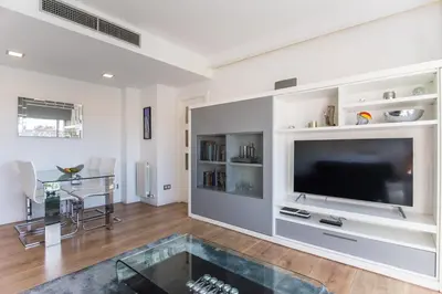a living room with a large flat screen tv at Glorious Sunny penthouse near the beach in Barcelona