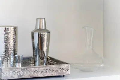 a silver container and a glass vase on a table at Glorious Sunny penthouse near the beach in Barcelona