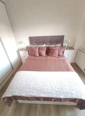 a bedroom with a large bed with pink pillows at Glorious Sunny penthouse near the beach in Barcelona
