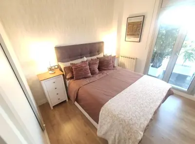 a bedroom with a large bed and a window at Glorious Sunny penthouse near the beach in Barcelona