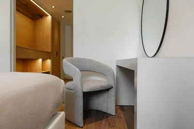 a bedroom with a chair next to a bed at Sweett - Paseo de Gracia - City Centre in Barcelona