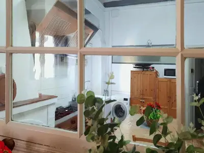 a living room with white furniture and a table at Farmhouse in Anoia near Montserrat in Capellades