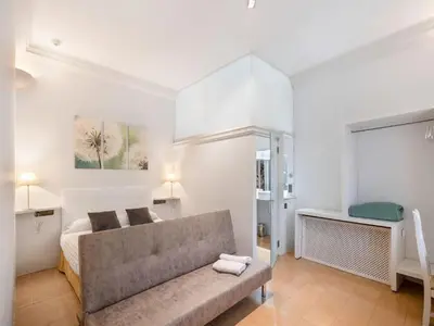 a small bedroom with a bed and a bathroom at Farmhouse in Anoia near Montserrat in Capellades
