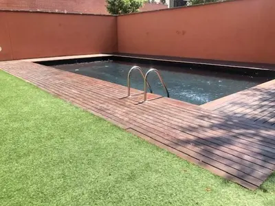 a pool of water with two metal bars in it at Quiet modern 2 bed apartment with Balcony, Pool and Free Parking in Barcelona