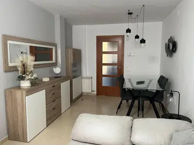 a living room with a couch and a dining room table at Holiday near Sitges with private terrace in Vilanova i la Geltrú